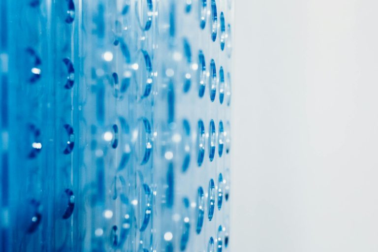 Close-up of an abstract blue surface featuring circular indentations creating a modern pattern.